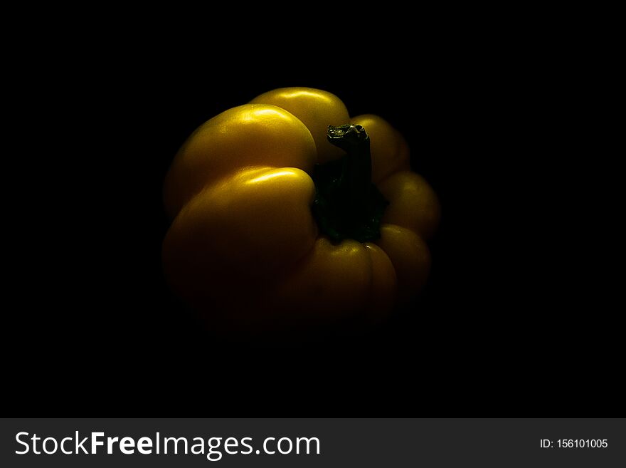 Fresh yellow capsicum paprika isolated on black. Healthy eating concept.