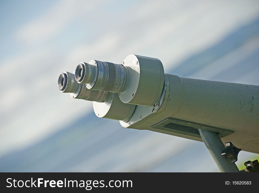 A closeup image of a binocular telescope in a fixed position for bird and Dolphin watchers. A closeup image of a binocular telescope in a fixed position for bird and Dolphin watchers.