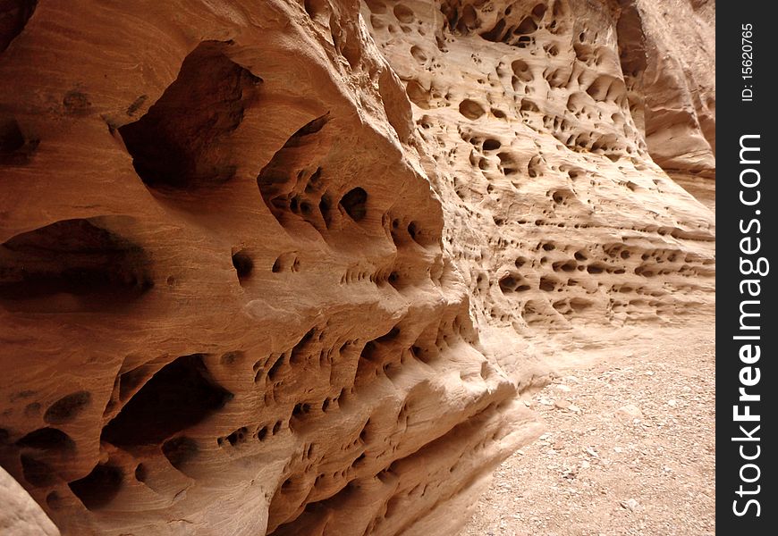 Some interesting holes carved out of a canyon wall. Some interesting holes carved out of a canyon wall