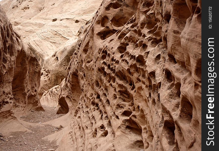Erosion in a sandstone wall that has created holes. Erosion in a sandstone wall that has created holes