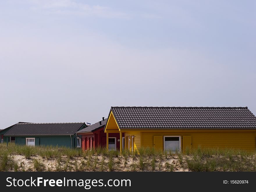 Green, red and yellow countryside houses on Dune island close to Helgoland, Germany.