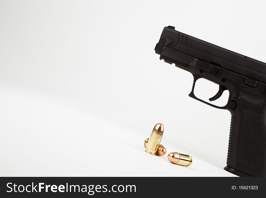 Gun and ammunition on an angle against a white background. Gun and ammunition on an angle against a white background