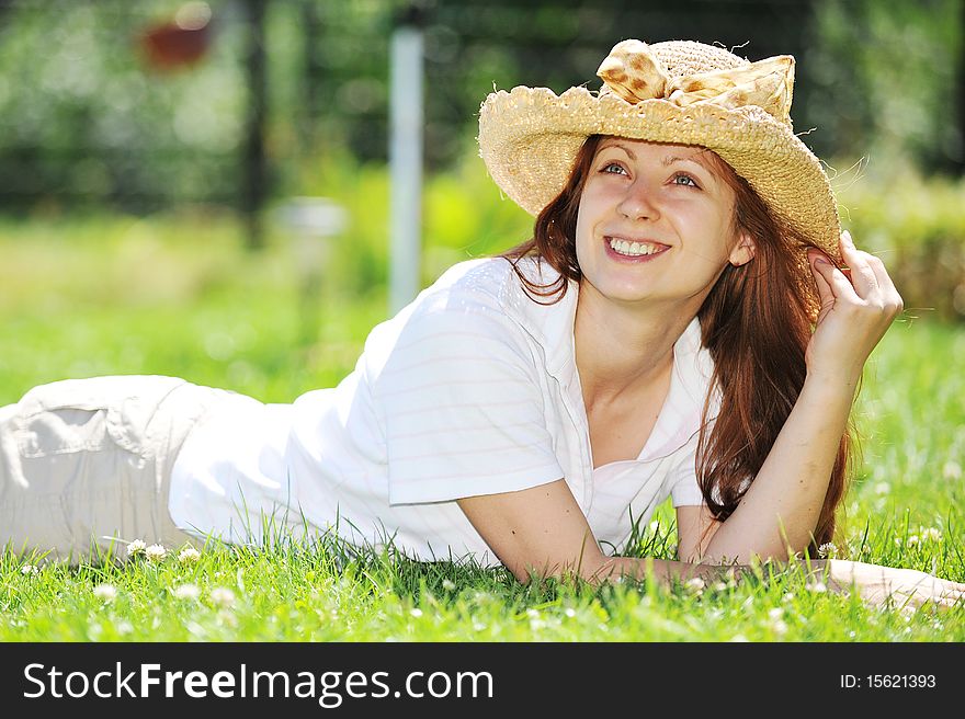 Young woman in straw hat relaxing outdoor