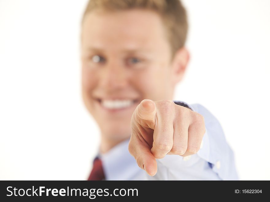 Smiling Young Businessman Pointing Finger At Camer