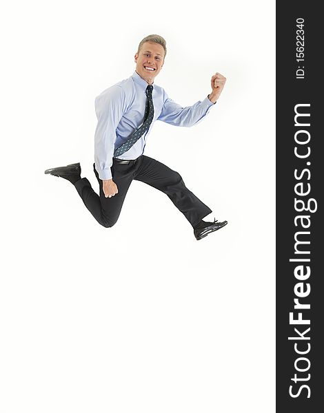 Smiling young businessman jumping in air with happiness. Smiling young businessman jumping in air with happiness