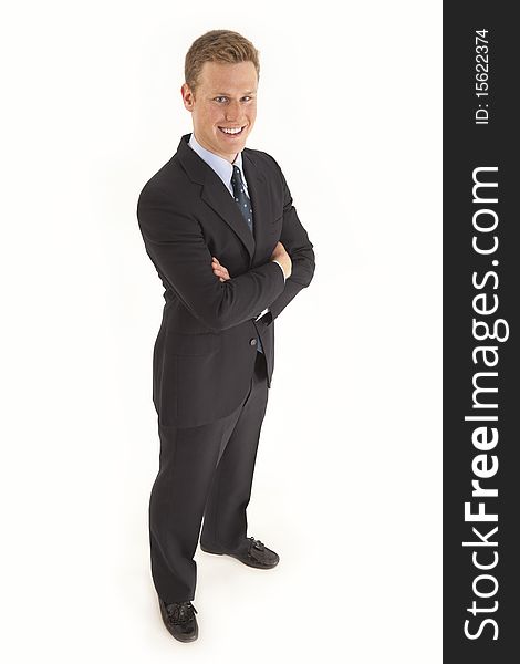 Full length portrait of young businessman standing with arms crossed. Full length portrait of young businessman standing with arms crossed