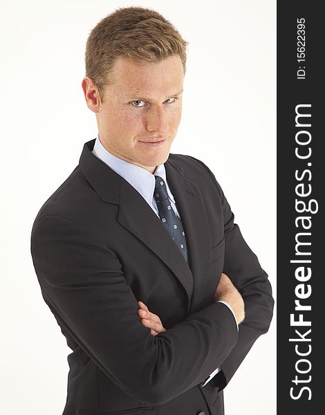 Portrait of young businessman standing with arms crossed. Portrait of young businessman standing with arms crossed