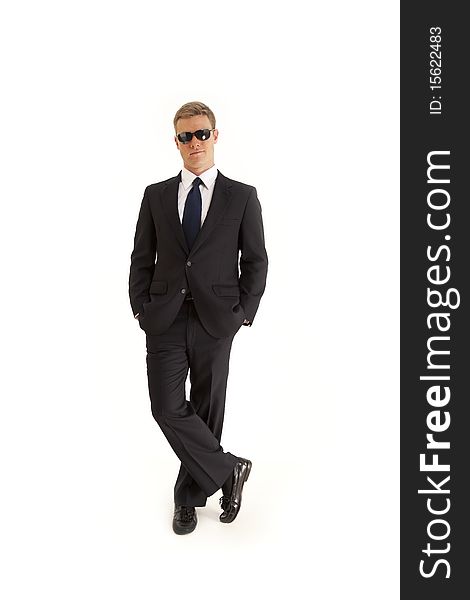 Full length portrait of confident young businessman wearing a suit and sunglasses. Full length portrait of confident young businessman wearing a suit and sunglasses