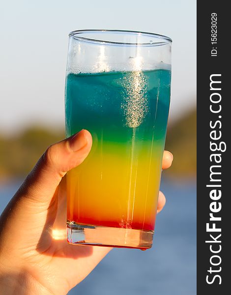 Colorful Alcoholic Drink Held In Hand