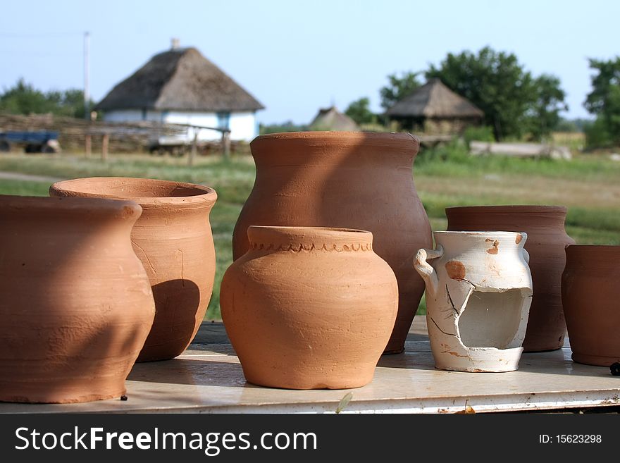 Clay the pots of handwork stand on a background rural landscape. Clay the pots of handwork stand on a background rural landscape