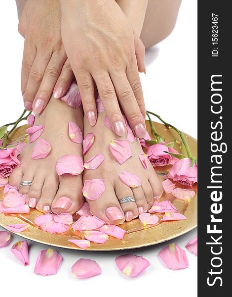 Woman  Feet With Flowers And  Petals Over White