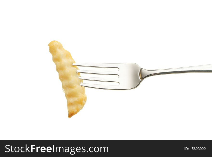 Crinkle cut potato chip on a fork isolated against white. Crinkle cut potato chip on a fork isolated against white