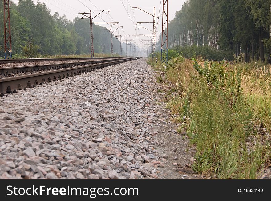 Railway rails leaving afar to horizon