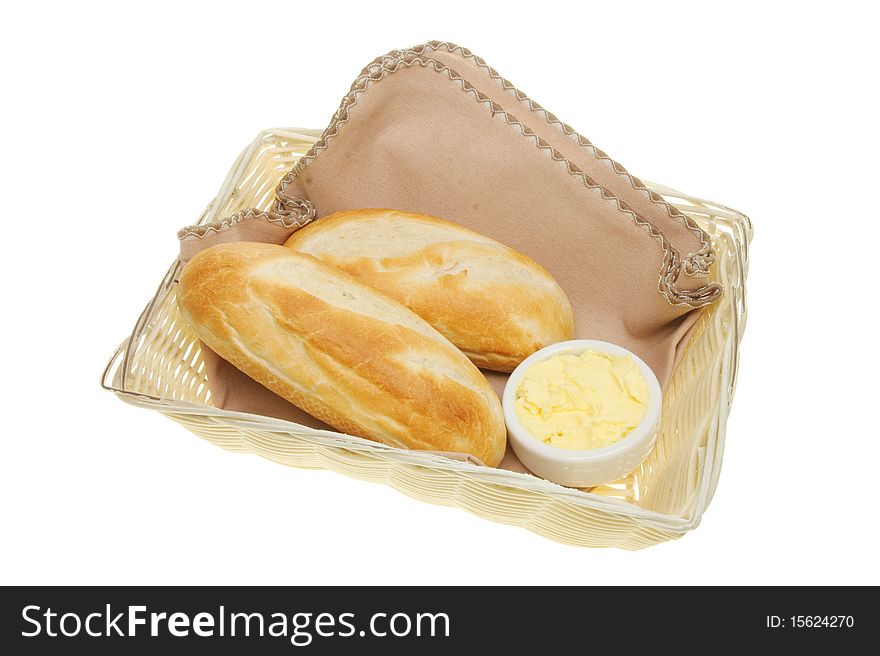 Baguette bread rolls and butter in a basket. Baguette bread rolls and butter in a basket