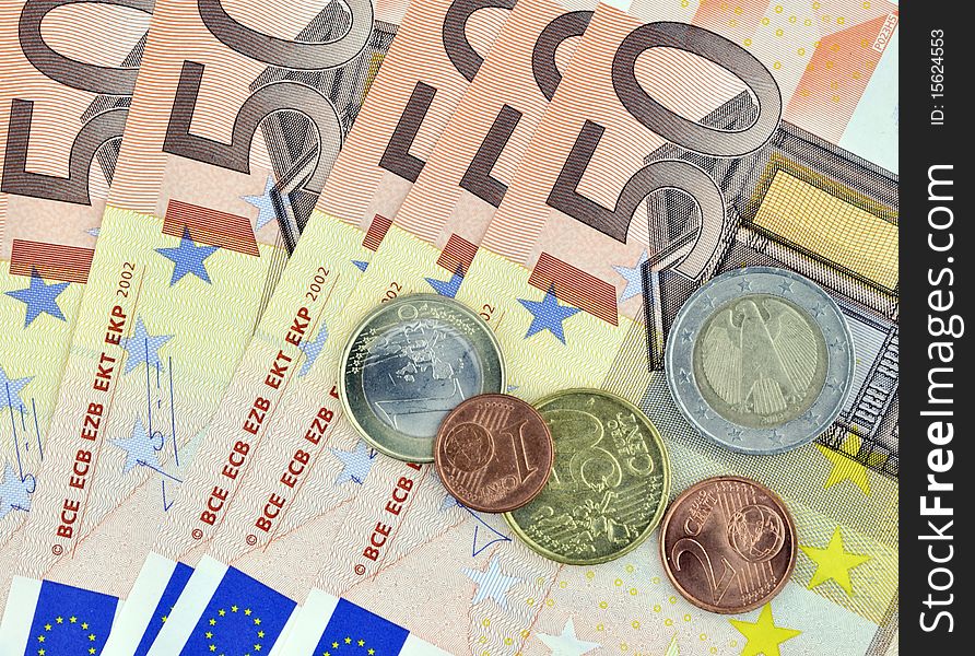 Closeup of fifty euro banknotes with coins. Closeup of fifty euro banknotes with coins