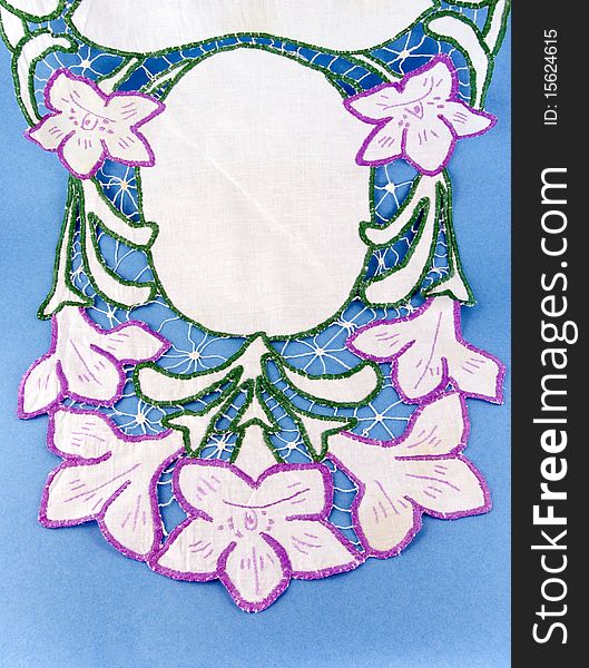 Embroidered napkin on blue background. Embroidered napkin on blue background