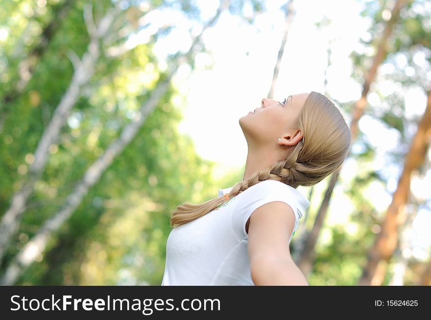 Young beautiful girl in a summer forest