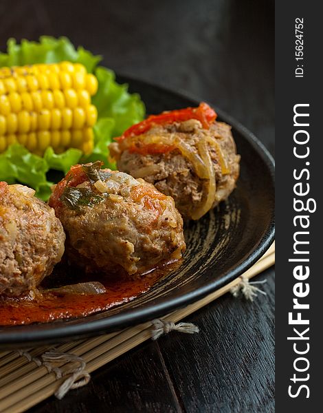 Meatballs served with corn and lettuce. Meatballs served with corn and lettuce