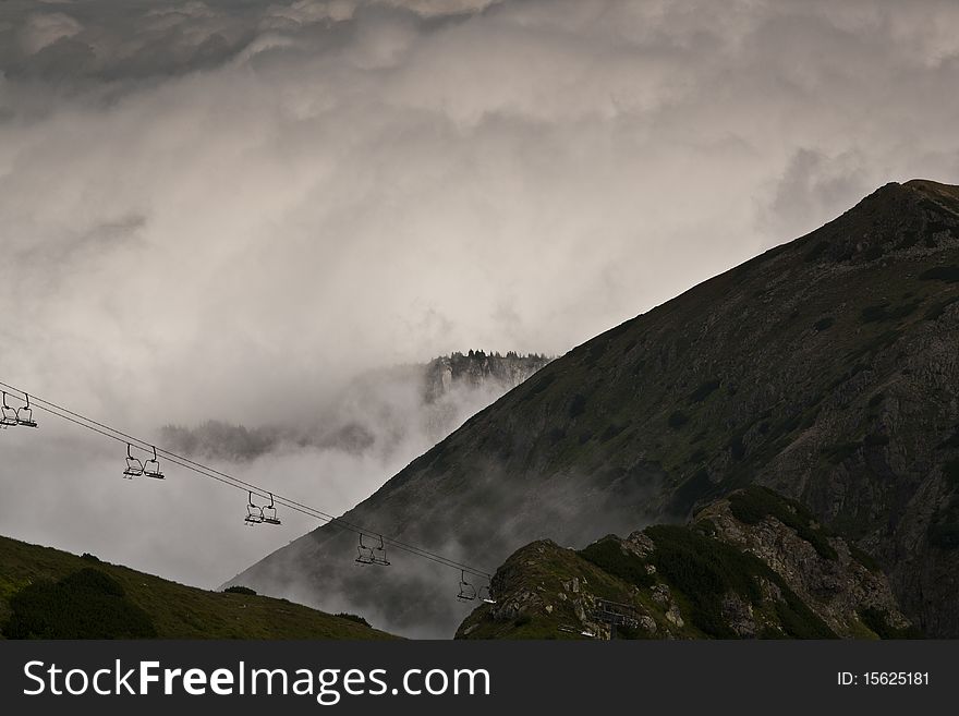 Cable lift in the high Tatras above dense clouds. Cable lift in the high Tatras above dense clouds