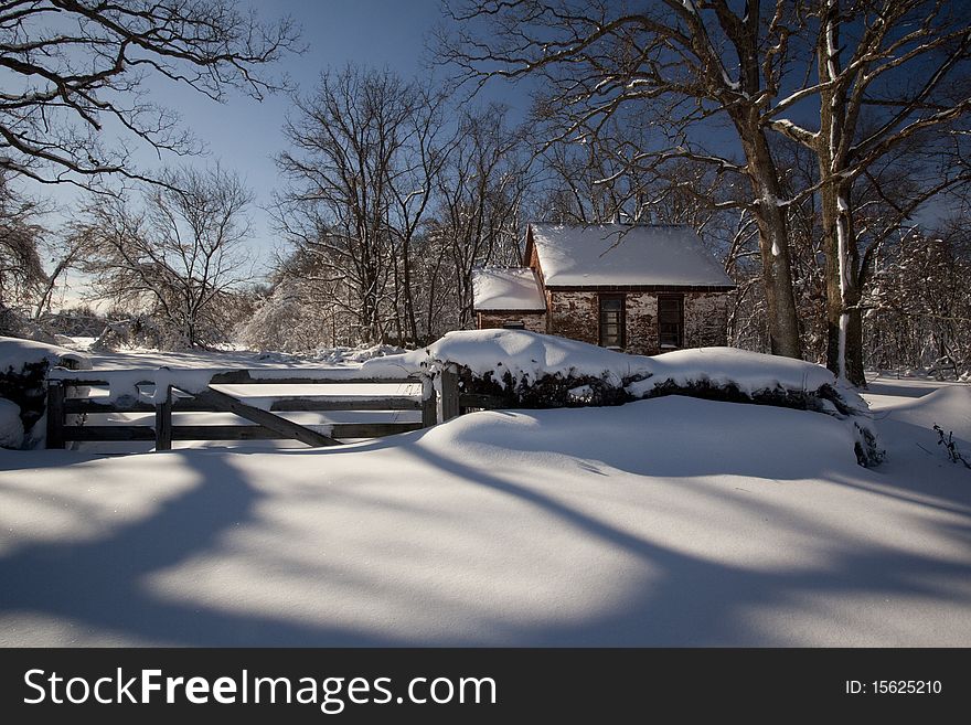 Little cabin in the woods in a very cald winter