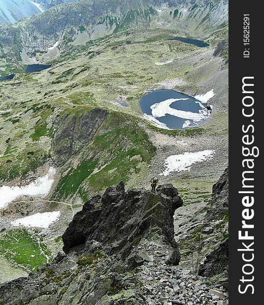 Mountaineer abseiling into alpine valley, High Tatras, Slovakia. Mountaineer abseiling into alpine valley, High Tatras, Slovakia