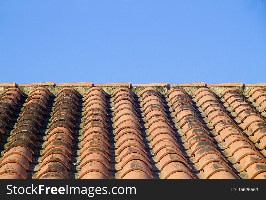 Roof with red tiles and blue skies