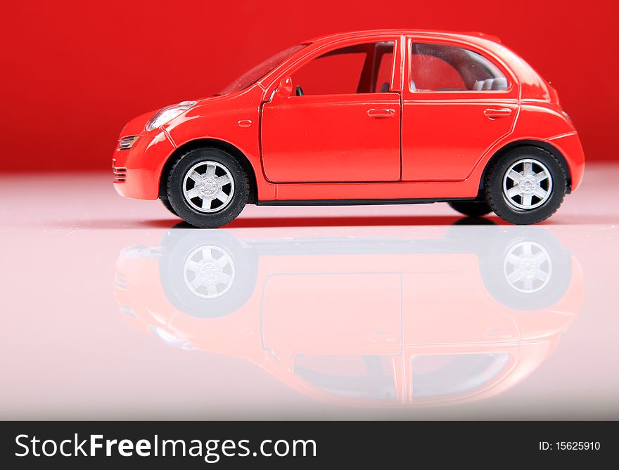 Nissan micra car shot in studio with red background.