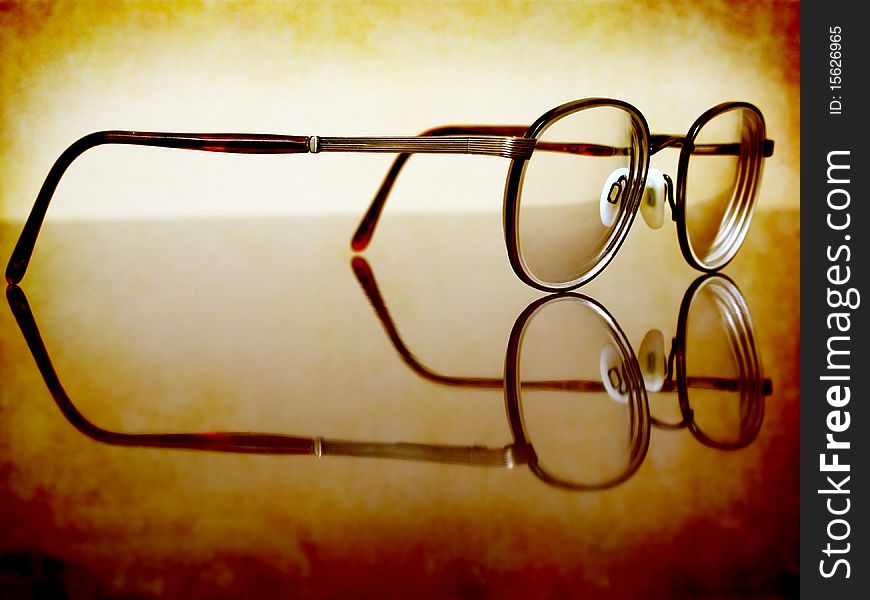 Closeup of Antique Eyeglasses on desk with reflection. Closeup of Antique Eyeglasses on desk with reflection