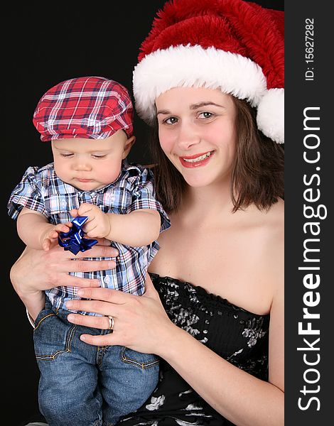 Beautiful christmas mother and son on a black background. Beautiful christmas mother and son on a black background