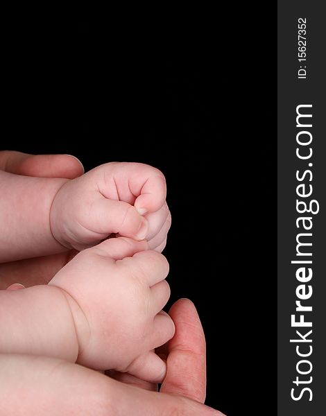 Caucasian mother and baby, baby holding mother's thumb. Caucasian mother and baby, baby holding mother's thumb