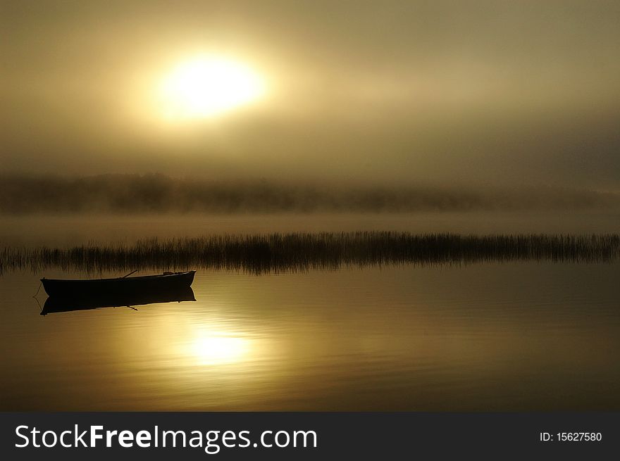 Early morning sun starting to burn through the fog/mist on an Ontario lake. Early morning sun starting to burn through the fog/mist on an Ontario lake.