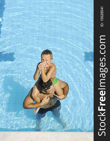 Happy father and son have fun at swimming pool. Happy father and son have fun at swimming pool