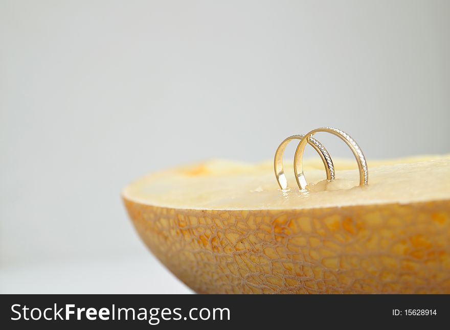 Wedding rings in a ripe melon