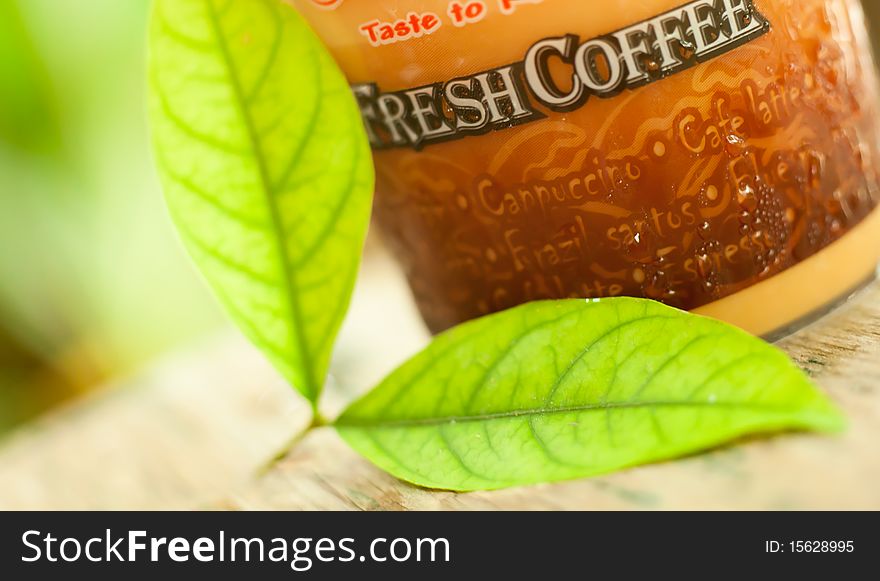 Backgroud coffee cup with green leaves