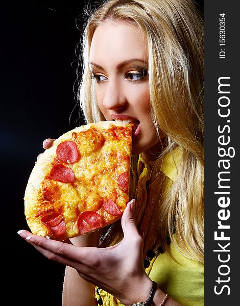 Beautiful woman eating fresh and tasty pizza