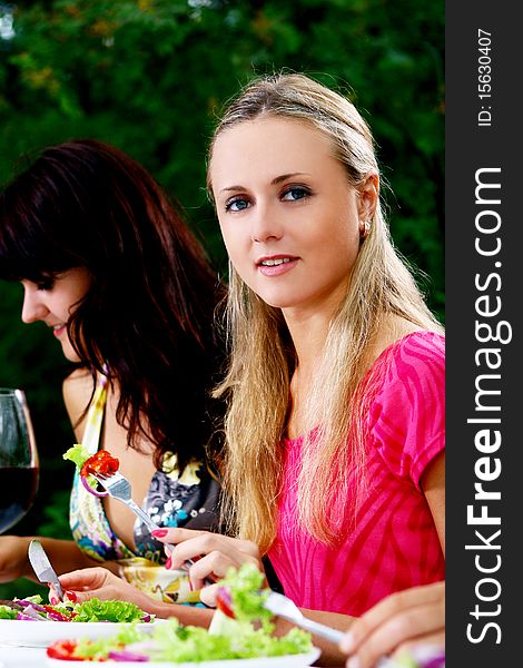 Group of beautiful girls drinking wine in the park