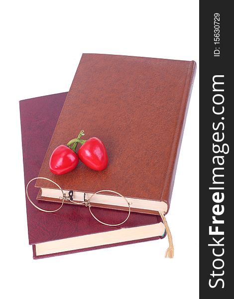 Old Books, Glasses And Chillies Isolated On White