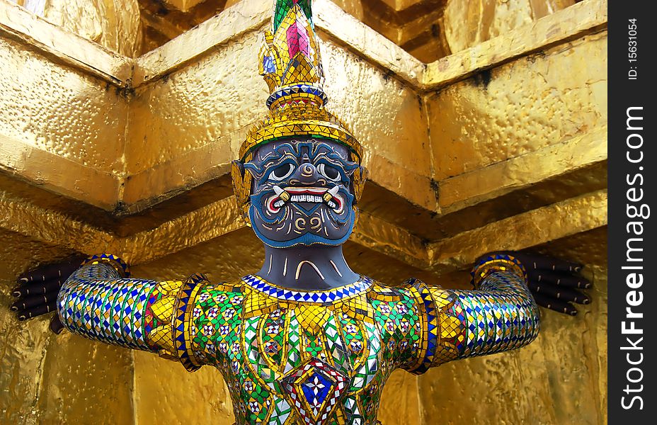 A close-up of a statue with a gold background at the Grand Palace in Bangkok, Thailand. A close-up of a statue with a gold background at the Grand Palace in Bangkok, Thailand.