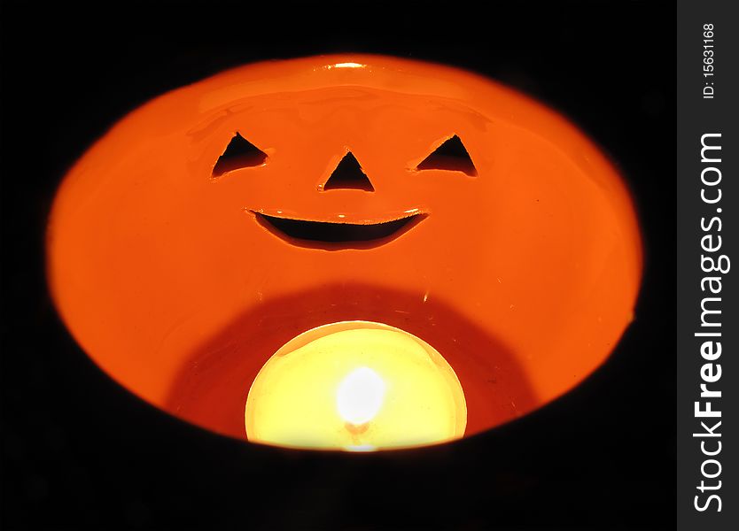 Candle inside a ceramic pumpkin