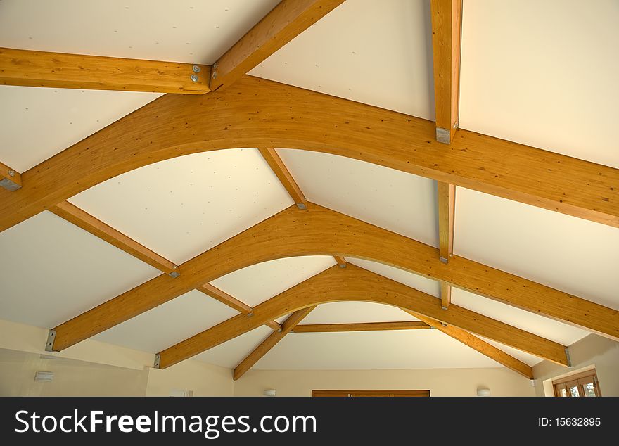 An image of the wooden beams supporting the roof over an indoor pool. An image of the wooden beams supporting the roof over an indoor pool.