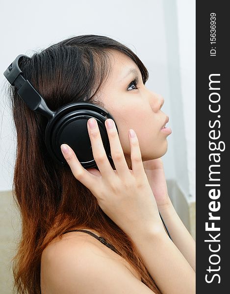 Female listening to music on headphones. Female listening to music on headphones