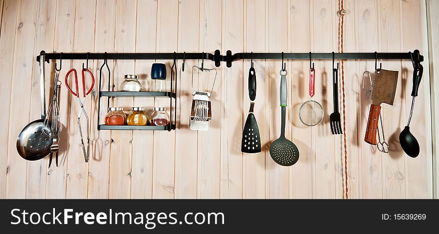 Kitchen utensils on wooden wall