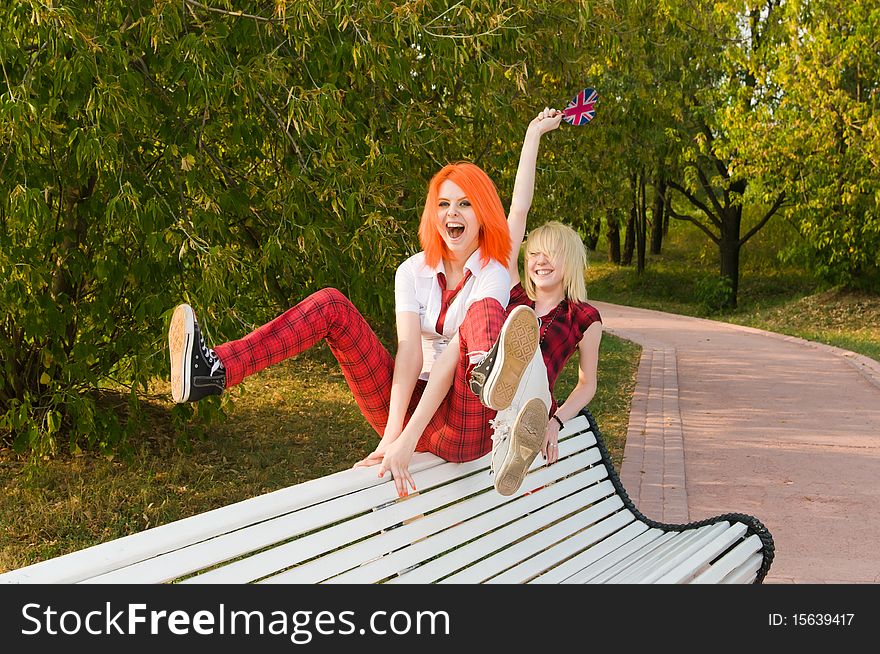 Two teenage girls have fun at the summer park