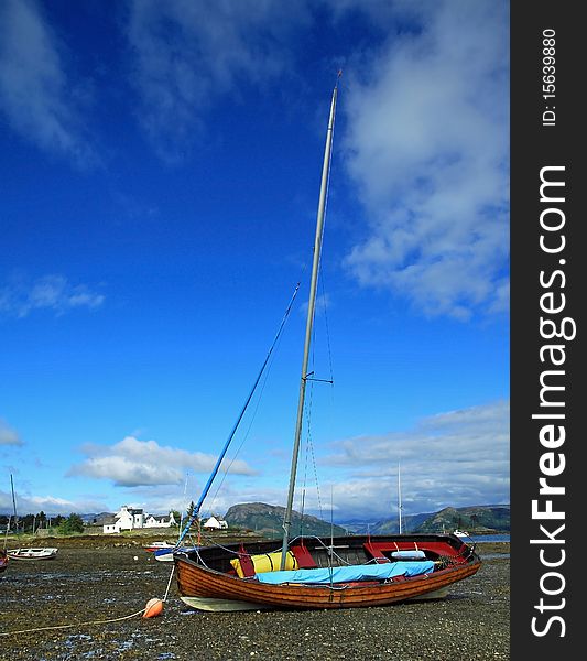 Sail boat anchored on plokton beach situated on the west coast of scotland. Sail boat anchored on plokton beach situated on the west coast of scotland