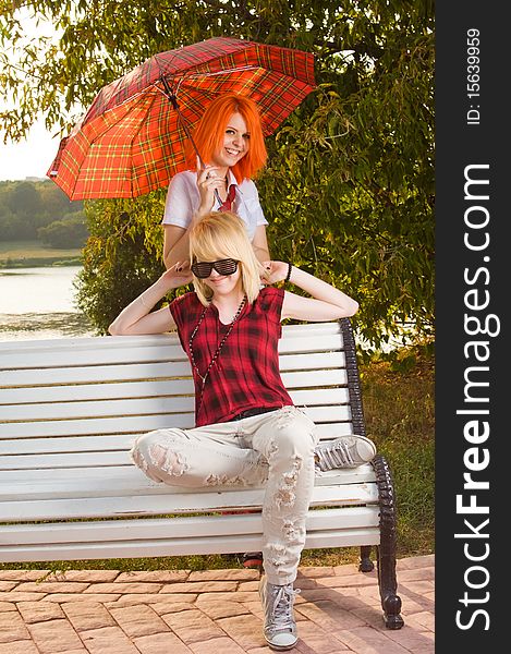 Two teenage girls have fun at the summer park