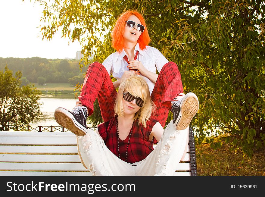 Two teenage girls have fun at the summer park