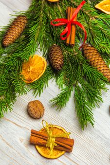 Christmas And New Year Composition. Pine Branches, Cinnamon Sticks, Dried Slices Of Orange And Walnuts. Christmas And Stock Photo