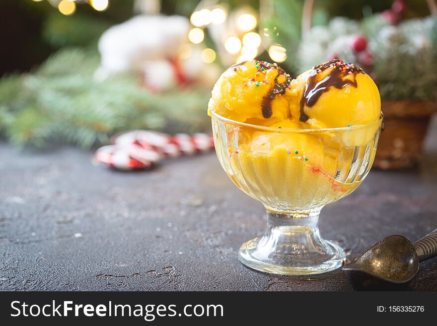 Glass bowl with delicious citrus ice cream on christmas background
