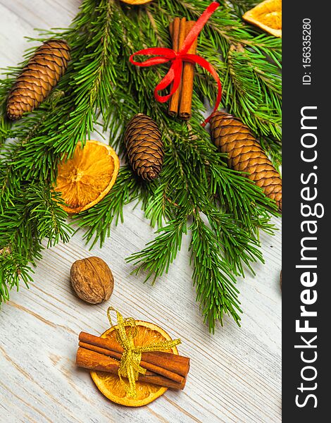 Christmas and New Year composition. Pine branches, cinnamon sticks, dried slices of orange and walnuts. Christmas and