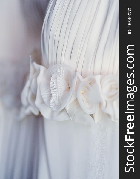 White wedding dress hangs on  hanger close up